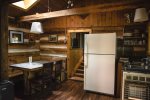 A tidy and functional kitchen with a full fridge and freezer
